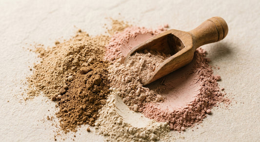 Luxury Ayurvedic close-up of raw Triphala and Rose Clay ubtan powder on sandstone